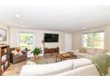 Spacious living room featuring hardwood floors, a comfortable sectional sofa, and natural light at 7771 Delbrook Dr, Indianapolis, IN 46260