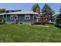Backyard view of home featuring a wood deck and large grass lawn at 8055 Foxchase Dr, Indianapolis, IN 46256