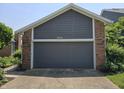 Exterior of garage with neutral siding and brick accent, with house number 8055 at 8055 Foxchase Dr, Indianapolis, IN 46256