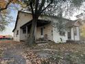 Charming home with a covered porch and a mix of architectural details, surrounded by fall foliage at 8345 N State Road 109, Wilkinson, IN 46186