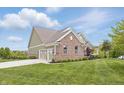 Spacious home with a brick facade, well-kept lawn, and a three-car garage, providing ample parking at 902 Racetime Rd, Westfield, IN 46074