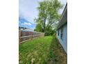 A fenced yard provides privacy and security with lush greenery and well-maintained landscaping at 9134 Jene Ct, Indianapolis, IN 46234