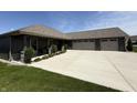Lovely home features a manicured lawn, spacious driveway, and a welcoming entrance at 920 Alba Dr, Lebanon, IN 46052