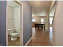 Hallway view featuring a half-bathroom and an open-concept dining and kitchen area at 9613 W Stargazer Dr, Pendleton, IN 46064