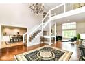 Elegant foyer featuring a staircase, high ceilings, chandelier and hardwood floors at 9790 Summerlakes Dr, Carmel, IN 46032