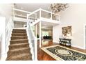 Grand foyer features a dramatic staircase, chandelier, and hardwood floors with a stylish rug at 9790 Summerlakes Dr, Carmel, IN 46032