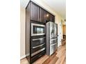 Modern stainless steel appliances, including a built-in microwave and double oven, enhancing the kitchen's functionality at 9860 Gallop Ln, Fishers, IN 46040