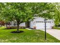 Landscaped front yard with a mature tree providing shade to this home at 10551 Huckleberry Ct, Noblesville, IN 46060