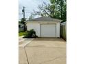 Detached single-car garage with white siding and a concrete driveway at 106 S Denny St, Indianapolis, IN 46201