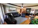 Comfortable living room with plush sectional sofa, accent chair, fireplace and hardwood floors at 1102 Redwood Dr, Brownsburg, IN 46112