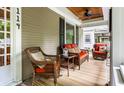 Relaxing front porch with wicker furniture and a ceiling fan at 114 E 44Th St, Indianapolis, IN 46205