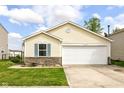 Lovely yellow house with a two-car garage, brick accents, and a neatly kept lawn on a sunny day at 11816 Wapiti Way, Noblesville, IN 46060