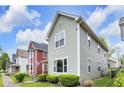 Side view of a two-story home highlighting the siding and window details on a sunny day at 1311 E Michigan St, Indianapolis, IN 46202