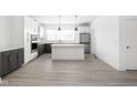 Bright open kitchen with gray and white cabinets, island, and stainless steel appliances at 1322 Colere Pl, Indianapolis, IN 46203