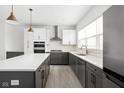 Well-appointed kitchen with white countertops, gray cabinets, and stainless steel appliances at 1322 Colere Pl, Indianapolis, IN 46203