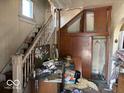 Entryway featuring a staircase with wood trim, and built-in storage solutions to enhance functionality at 155 S Elder Ave, Indianapolis, IN 46222