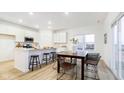 Bright kitchen with white cabinets, a breakfast bar, and an adjacent dining area perfect for entertaining at 1577 Vision Ct, Danville, IN 46122