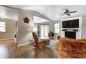 Bright living room with vaulted ceilings, white brick fireplace, and modern ceiling fan at 1604 Stacy Lynn Dr, Indianapolis, IN 46231