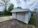 Detached single car garage with fresh white siding, providing parking and storage at 1614 Dayton Ave, Indianapolis, IN 46203