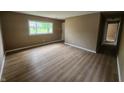 Bright living room with large window and neutral walls and laminate flooring at 1614 Dayton Ave, Indianapolis, IN 46203