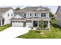 Charming two-story home featuring a three-car garage, brick accents, and a well-manicured lawn at 19442 Honeylocust Glen, Noblesville, IN 46062