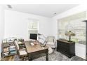 Bright home office with a wooden desk, comfortable chair, and window for natural light at 19442 Honeylocust Glen, Noblesville, IN 46062