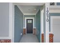 Inviting front porch with brick accents and a stylish front door, showcasing the home's entrance at 19570 Forsythe Dr, Noblesville, IN 46060