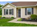 Close-up view of the front door and exterior of the home, highlighting the landscaping at 204 Oakview Dr, Mooresville, IN 46158