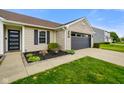Well-maintained front yard with mature landscaping and a walkway to the front door at 204 Oakview Dr, Mooresville, IN 46158