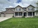 Charming two-story home featuring a welcoming front porch and three-car garage at 2680 Newington Ln, Carmel, IN 46074