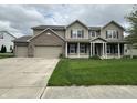 Charming two-story home featuring a welcoming front porch and three-car garage at 2680 Newington Ln, Carmel, IN 46074
