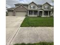 Charming two-story home featuring a welcoming front porch and three-car garage at 2680 Newington Ln, Carmel, IN 46074