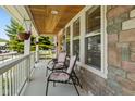 Relaxing front porch with comfortable seating and natural wood ceiling accents at 2919 Macpherson Ave, Indianapolis, IN 46205