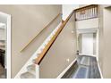 Bright stairway featuring neutral walls, soft carpet, and a wooden handrail, leading to the upper level at 3002 Horse Hill W Dr, Indianapolis, IN 46214