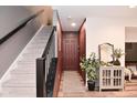 Welcoming foyer with staircase, featuring neutral decor and a stylish console table with mirror at 3110 W New York St, Indianapolis, IN 46222