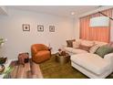 Comfortable living room showcasing a plush sectional, accent chair, decor, and lots of natural light at 3110 W New York St, Indianapolis, IN 46222