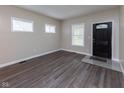 Bright entryway showcasing wood flooring and a decorative front door at 3216 N Kenwood Ave, Indianapolis, IN 46208