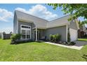 Attractive home featuring lush landscaping, a welcoming entrance, and a spacious front yard at 3341 Enclave Xing, Greenwood, IN 46143