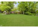 Well-manicured front yard with mature trees and landscaping surrounding a traditional-style home at 3698 E 106Th St, Carmel, IN 46033