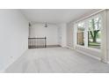 Bright living room with neutral carpet, large windows, and staircase with railing at 3698 E 106Th St, Carmel, IN 46033