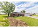 Charming single-story brick home with a well-maintained front yard, mature trees and an attached garage at 5457 W 900 North, McCordsville, IN 46055