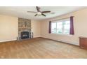 Spacious living room featuring a stone fireplace, plush carpeting, ceiling fan and ample natural light at 5457 W 900 North, McCordsville, IN 46055