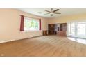 Comfortable living room with large windows, a ceiling fan, and built in shelves for extra storage at 5457 W 900 North, McCordsville, IN 46055