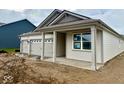 Attractive single-story home with a three-car garage and covered porch entry at 5863 Handbell Ln, Greenwood, IN 46143