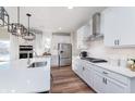 Bright kitchen with quartz countertops, subway tile backsplash, stainless appliances and contemporary pendant lighting at 591 Dalton Way, Avon, IN 46123