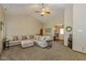 Open-concept living room with vaulted ceiling, carpeted floor, comfortable sofa, and view of entry at 6138 Bartley Ct, Indianapolis, IN 46236