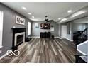 Spacious living room with fireplace, modern ceiling fan, and grey-toned walls at 6155 W Bayfront, McCordsville, IN 46055