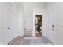 Bright foyer with luxury vinyl plank flooring, white walls, closet space, and half bath access at 6460 Wasco Dr, Whitestown, IN 46075