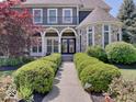 Inviting home features a stone turret and manicured landscaping, leading to a welcoming entrance at 6648 Westminster Dr, Zionsville, IN 46077