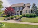 Attractive two-story home boasts manicured landscaping, stone accents, and inviting curb appeal at 6648 Westminster Dr, Zionsville, IN 46077